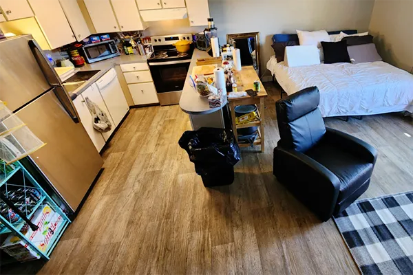 An after photo of the same living space shown in the previous image. In the after photo the space has been cleaned, organized, and rearranged for access and livability